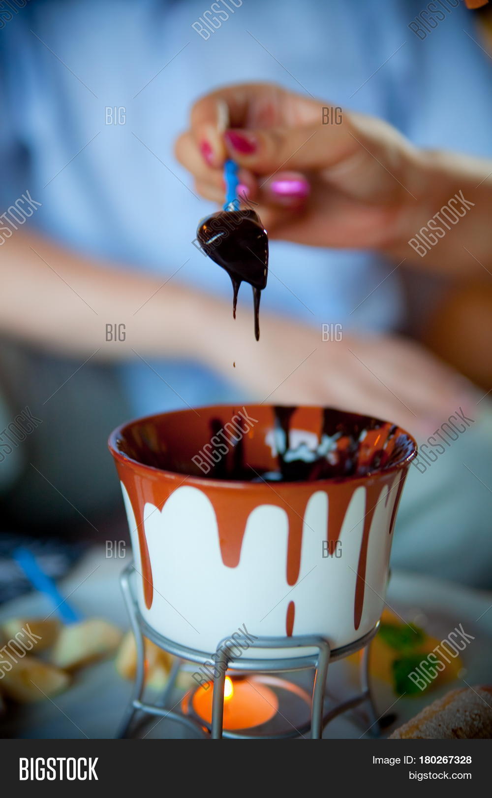 chocolate fondue with fruits in the blue pot, a delicious