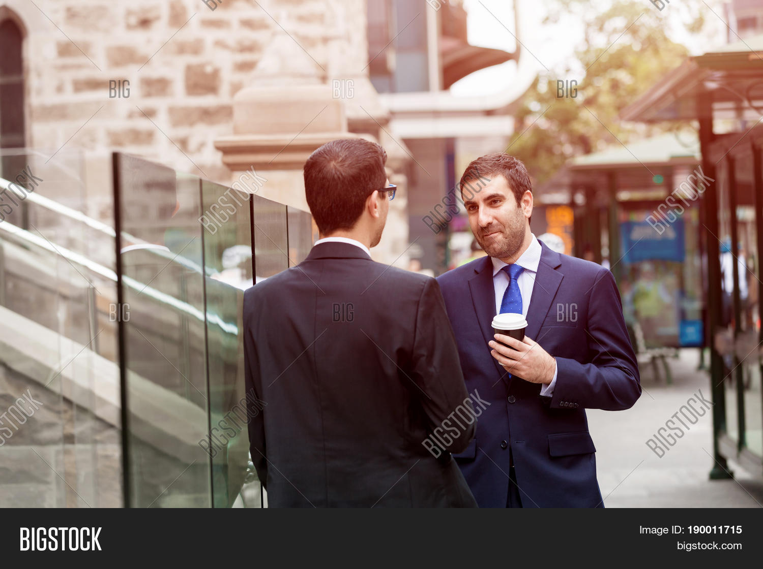 two businessmen talking outdoors
