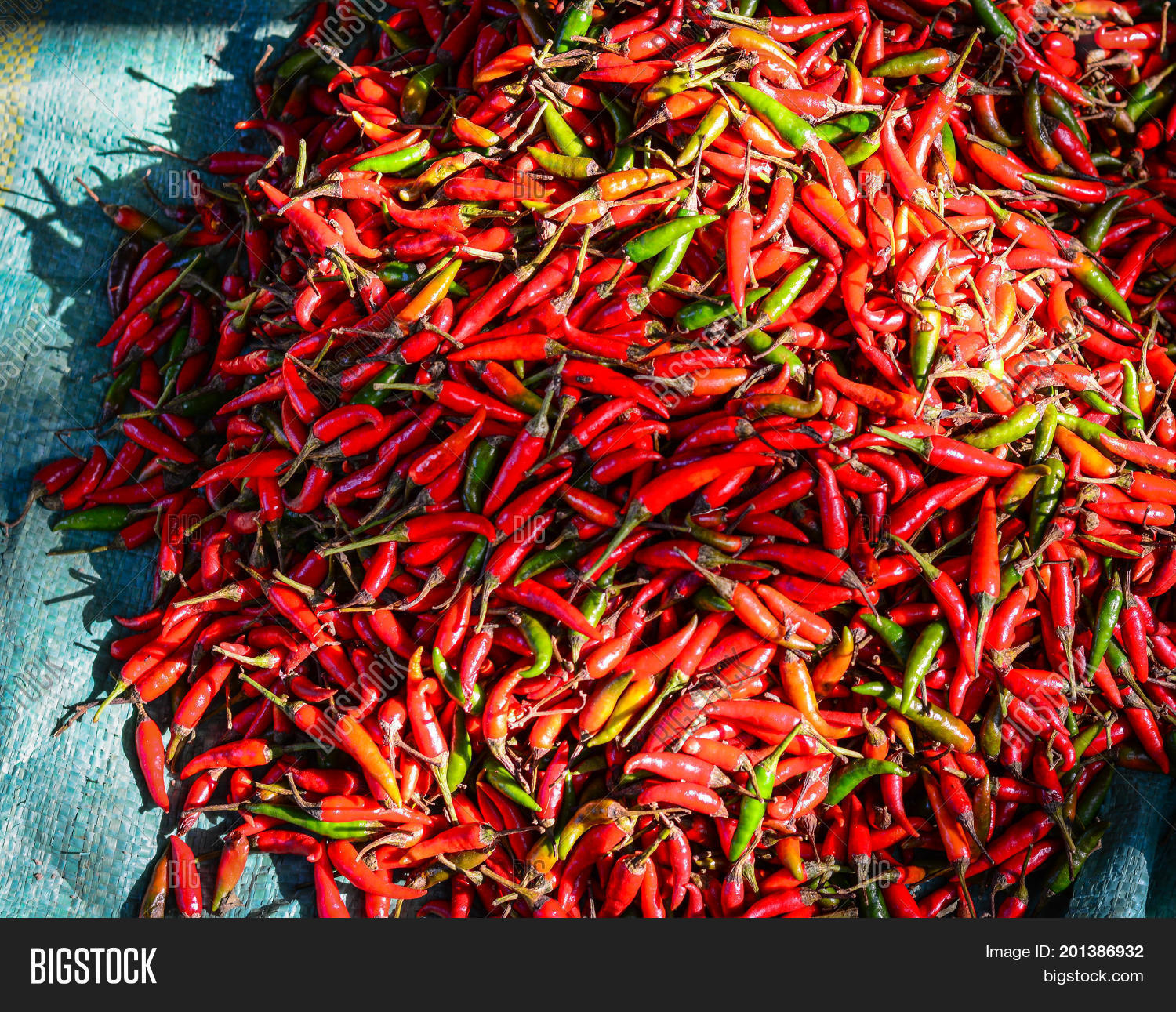 pile of fresh red chilli peppers at a rural market in mekong