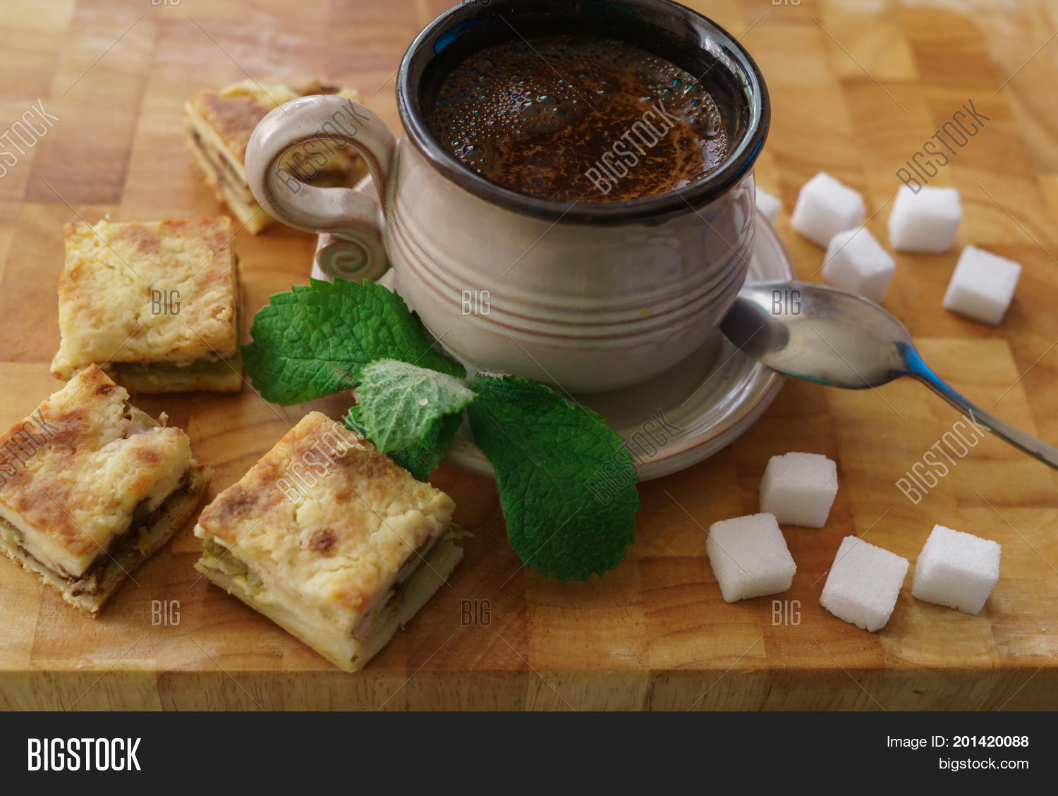 a cup of fresh coffee with pieces of cake.