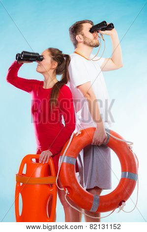 lifeguards on duty looking through binoculars