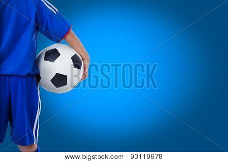 back view of youth soccer player in blue uniform