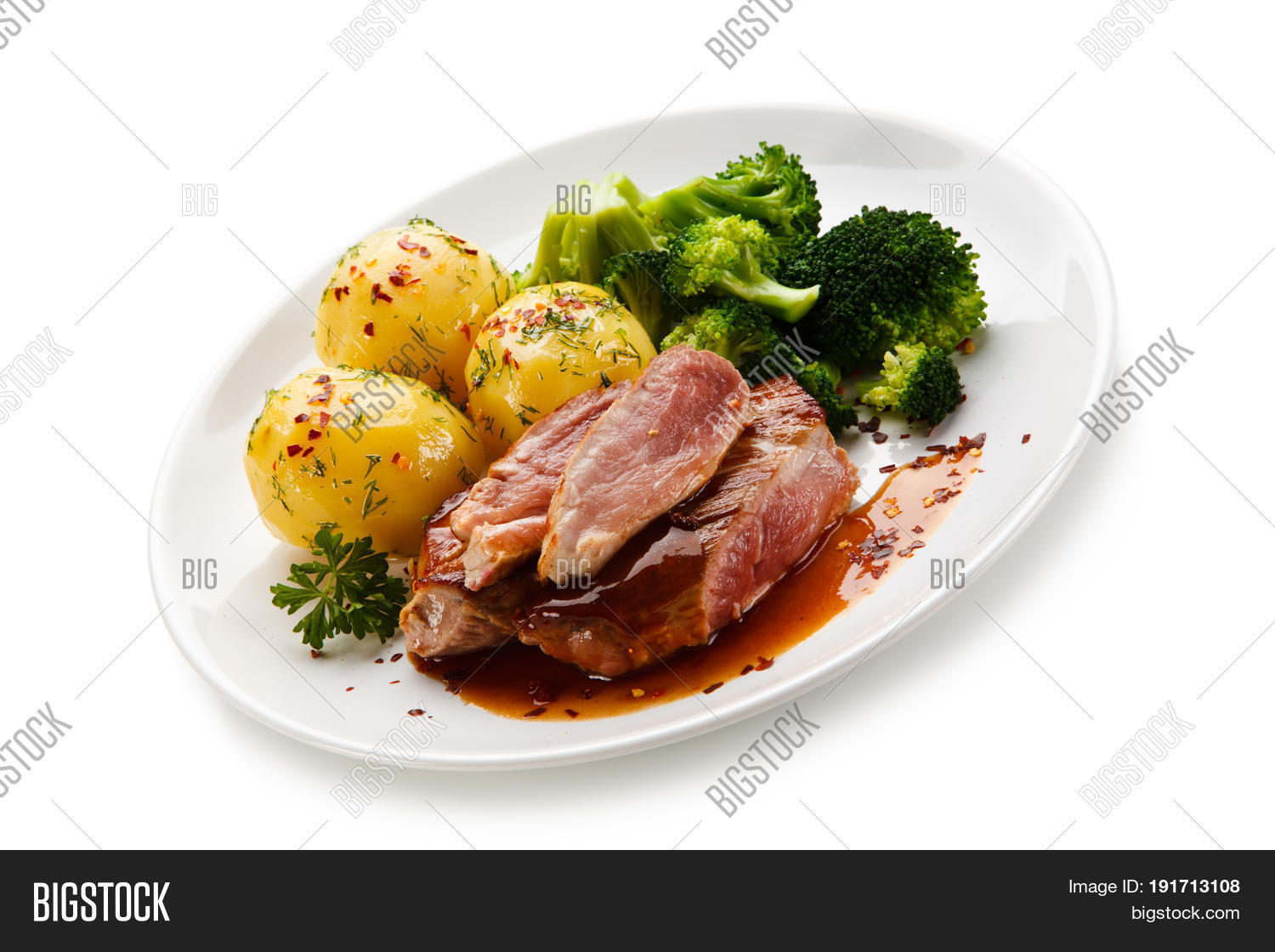 grilled beefsteak with broccoli and carrot on white background