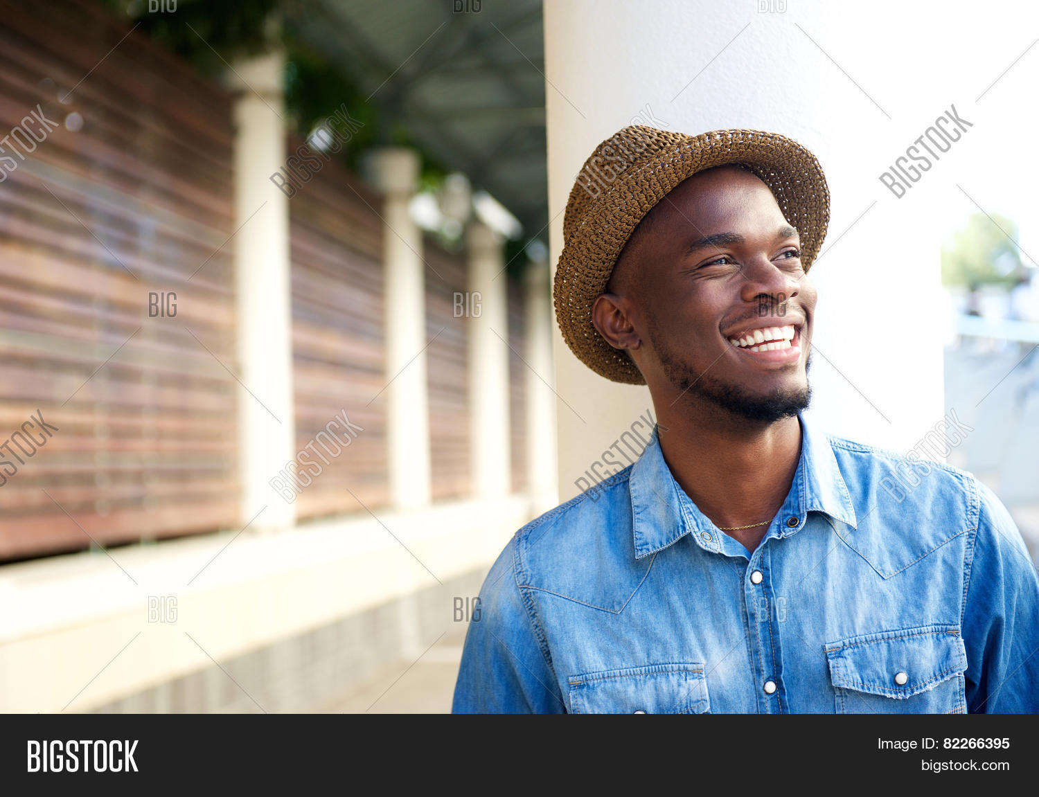 up portrait of a cheerful young african american man laughing