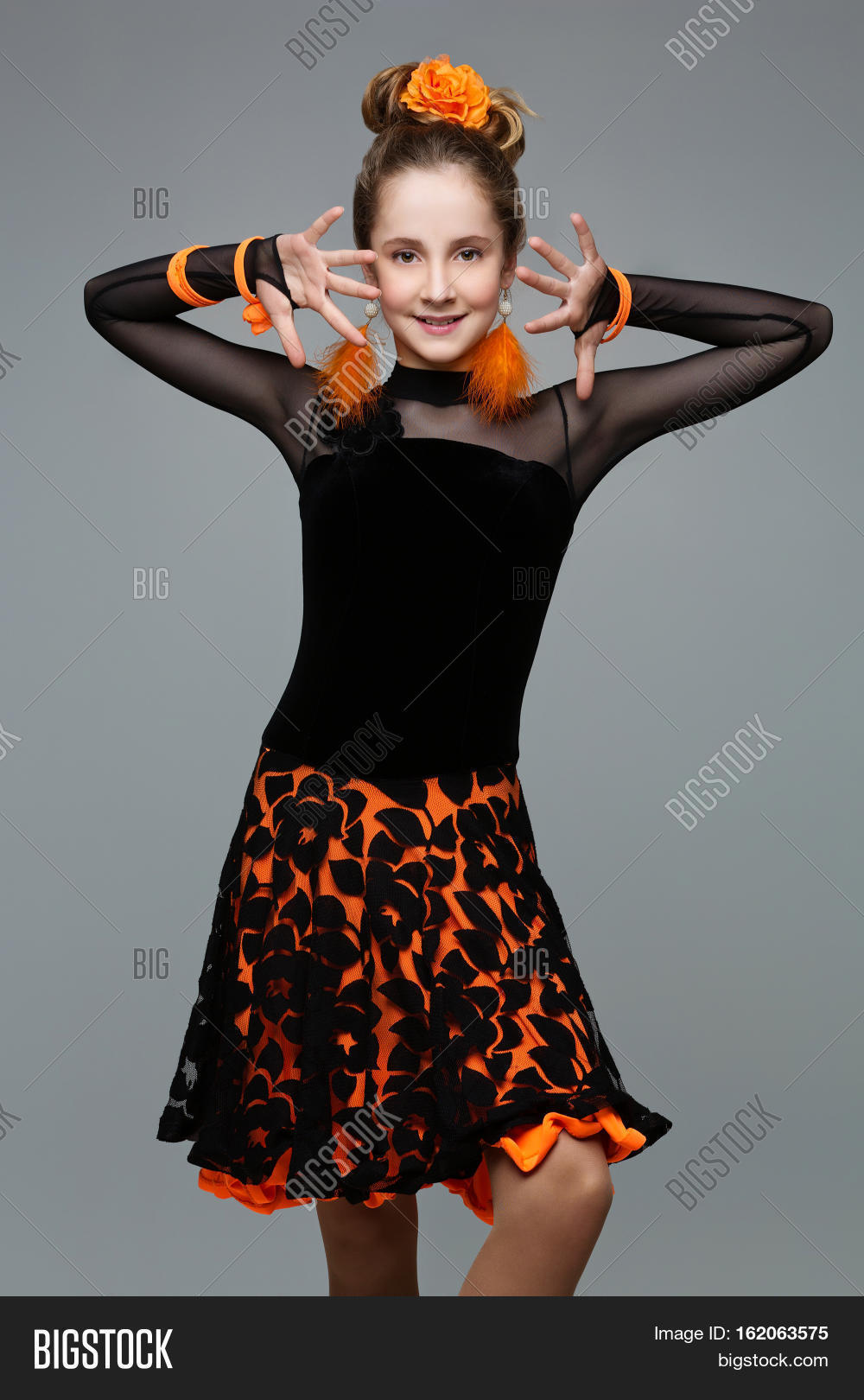 beautiful teenage ballroom dancer girl in black and orange