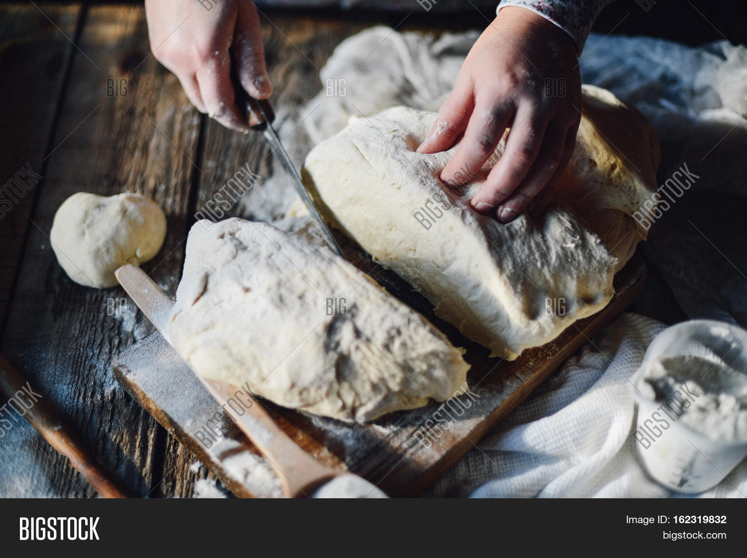 close up view of baker kneading dough. homemade bread.