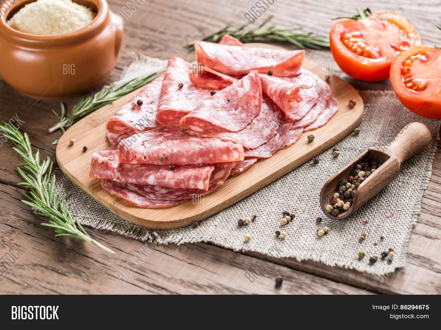 slices of salami on the wooden board