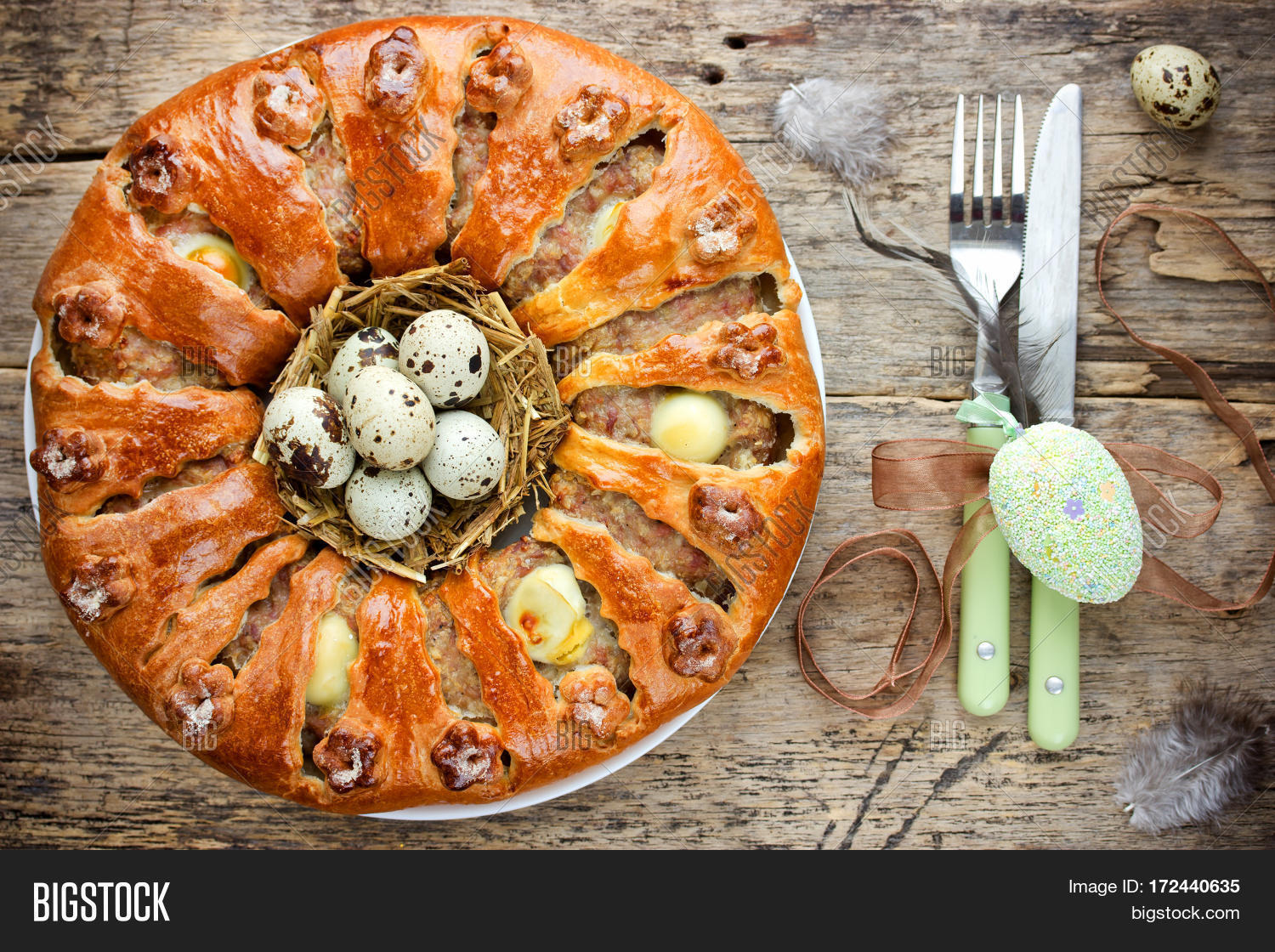 easter bread ring stuffed with minced meat and quail eggs on old