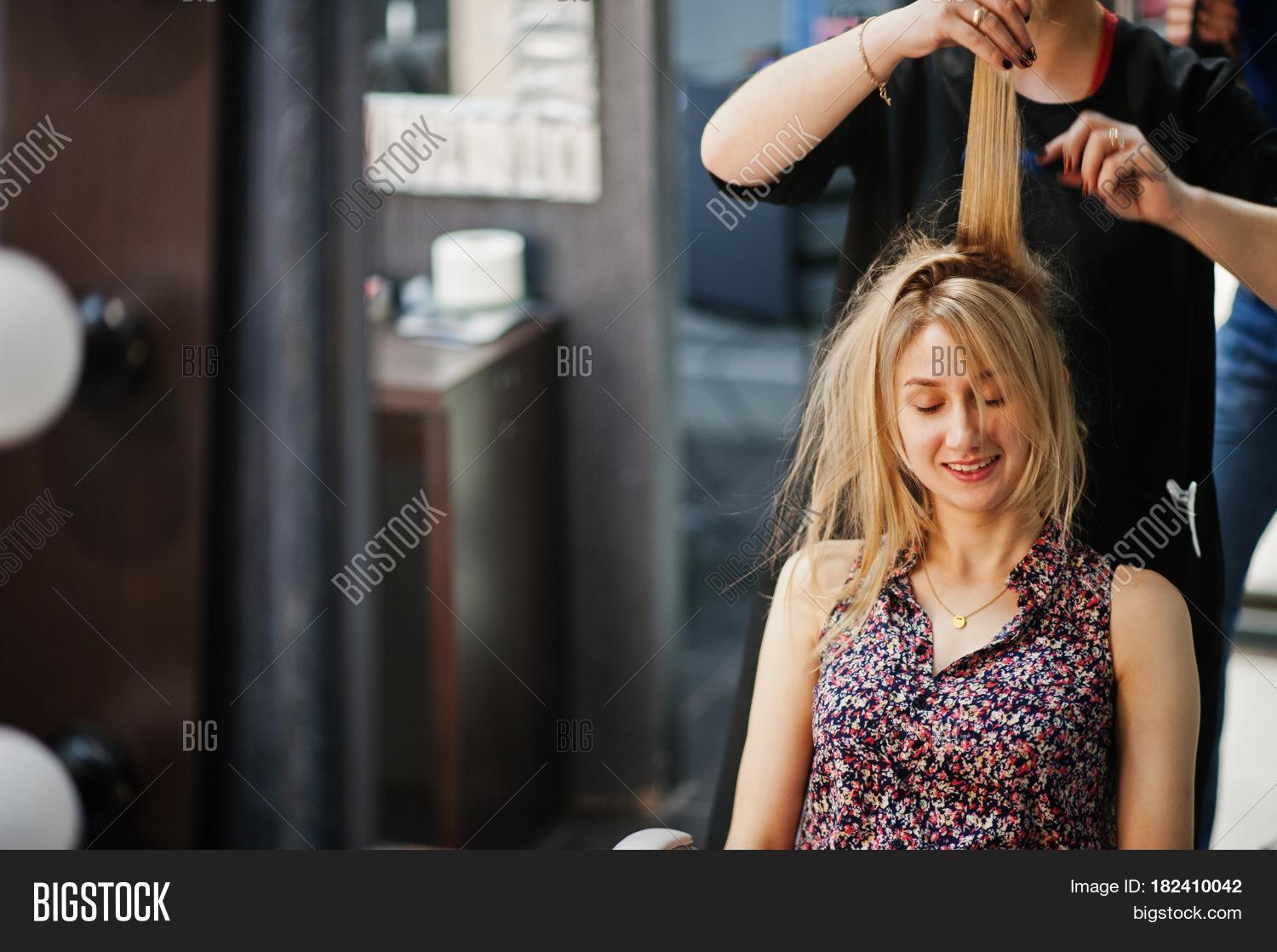 hair stylist makes the bride a wedding hairstyle at beauty salon