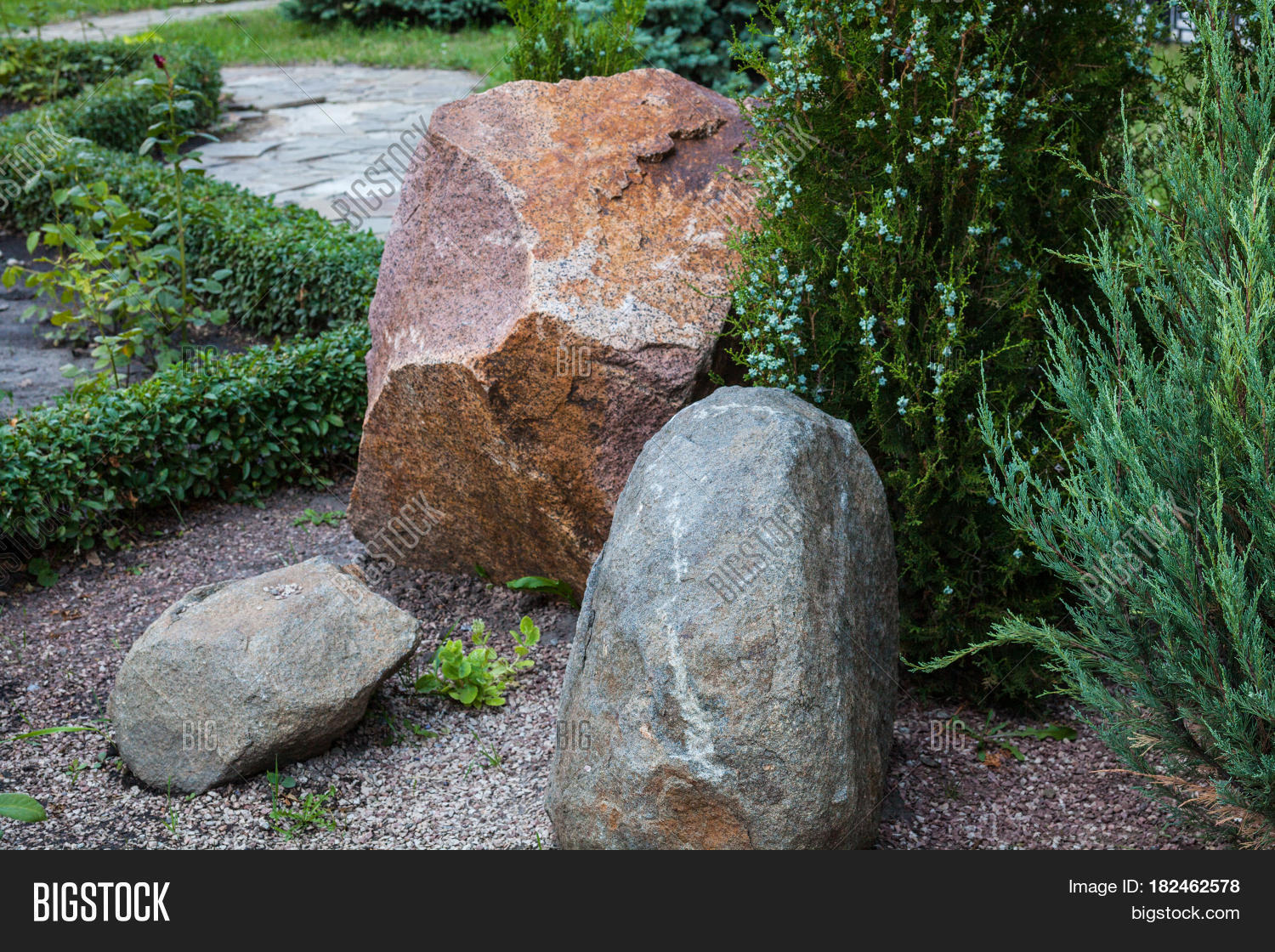 rockery with big stones and different evergreen plants (oriental