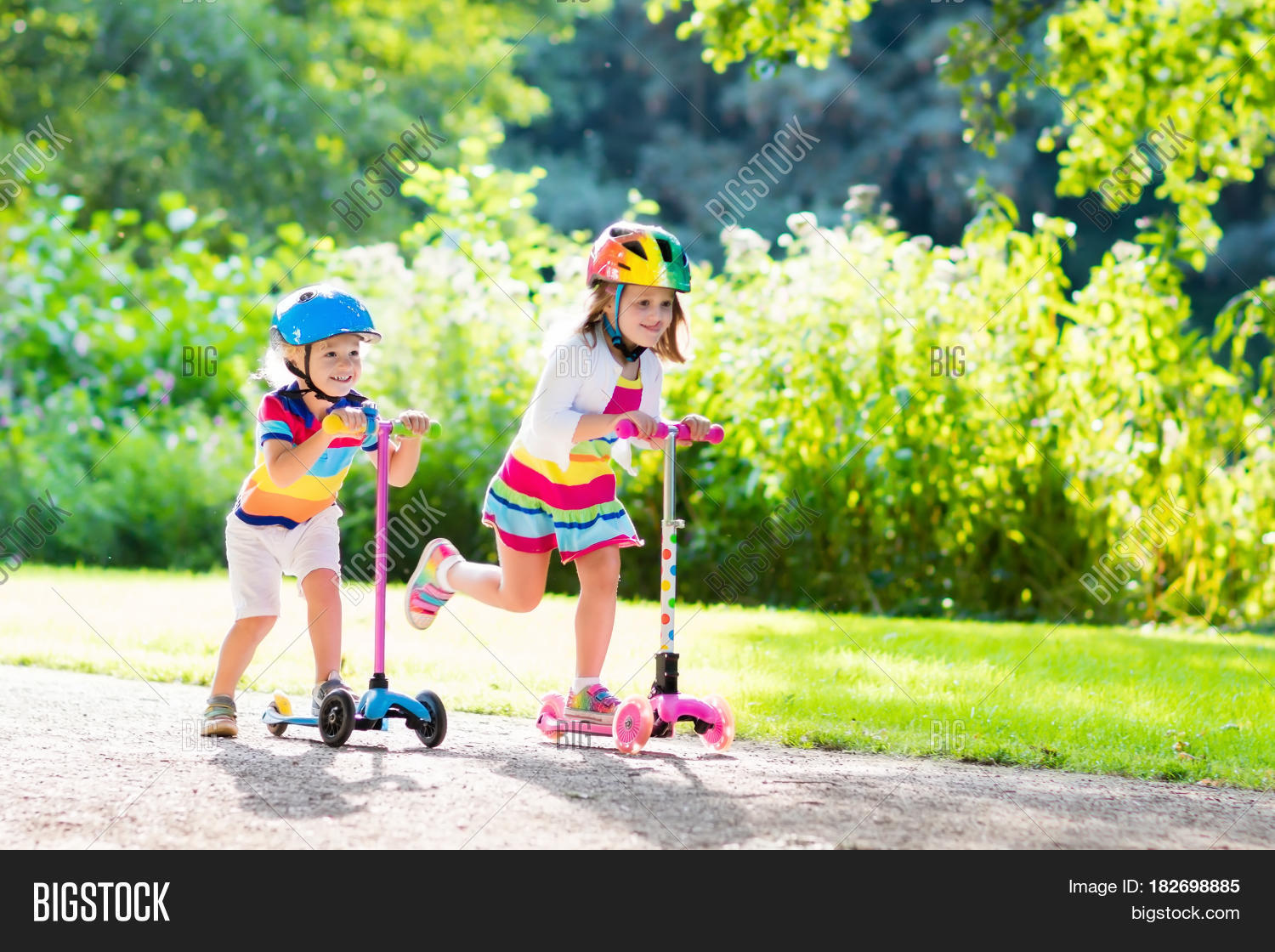 kids riding scooter in summer park. 库存照片和库存图片 | bigstoc
