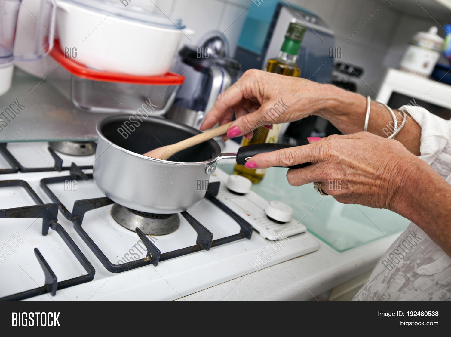cropped image of senior woman cooking at kitchen counter