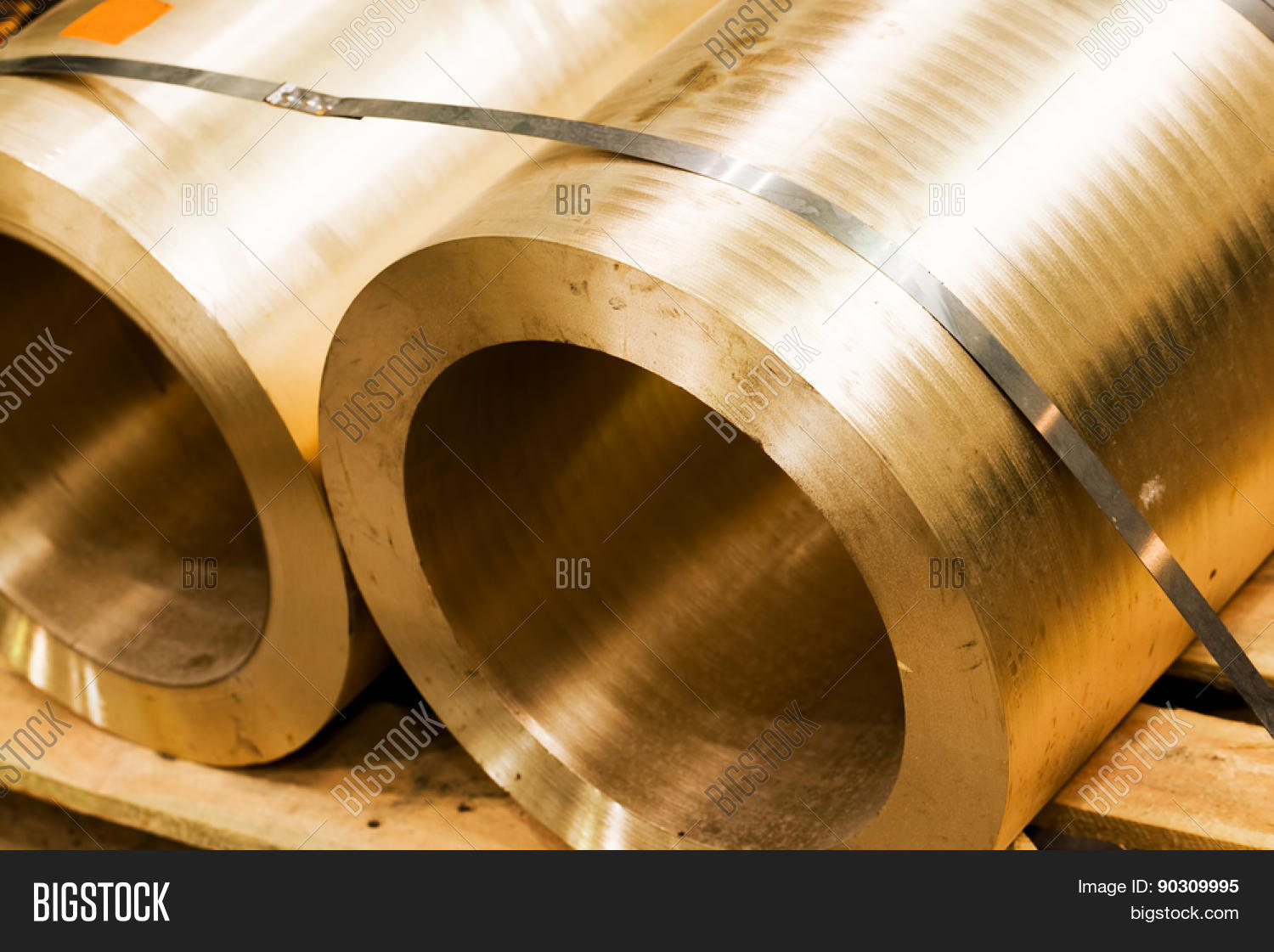 industrial hardened steel cylinders in workshop.