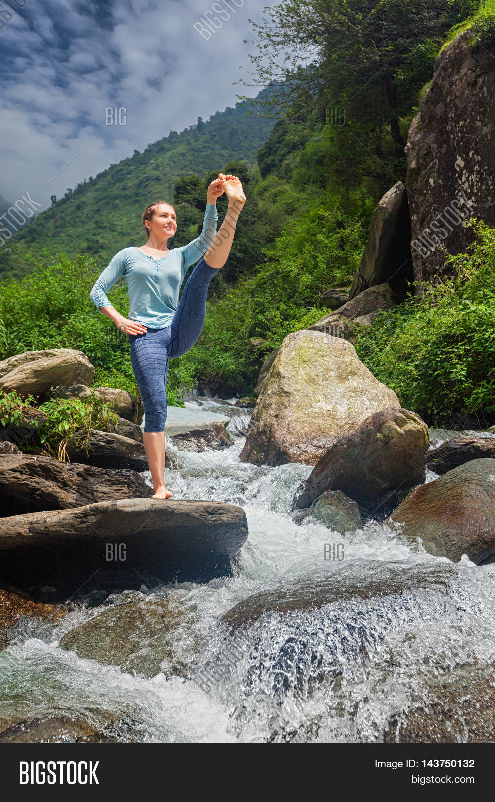 yoga outdoors - woman doing ashtanga vinyasa yoga balance asana