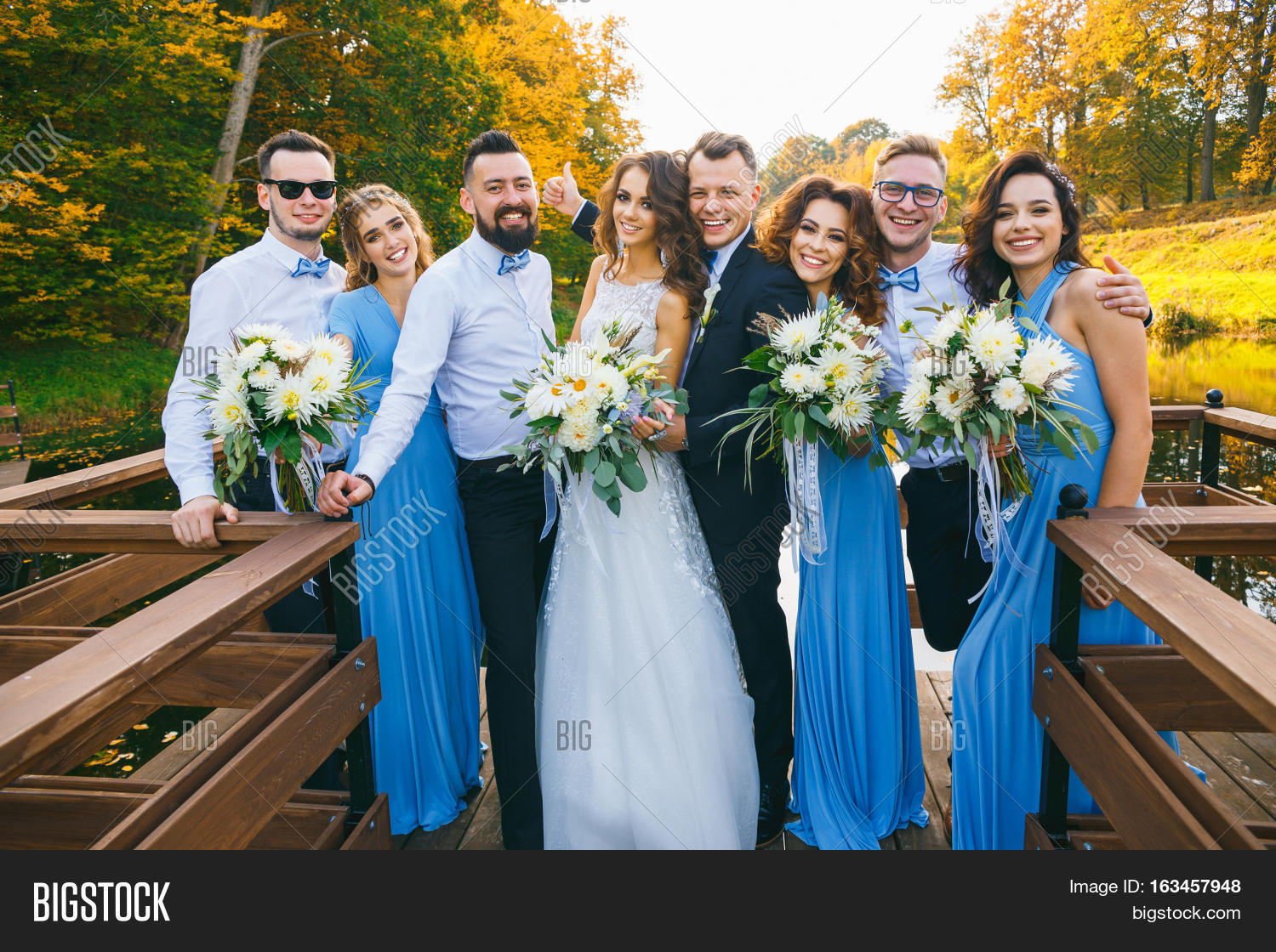 couple with groomsmen and bridesmaids posing on wedding ceremony