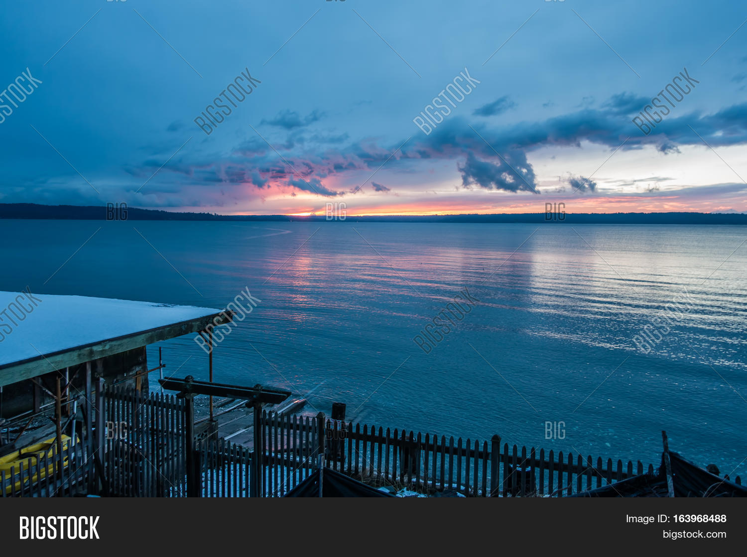 the sun sets behind the puget sound in winter.