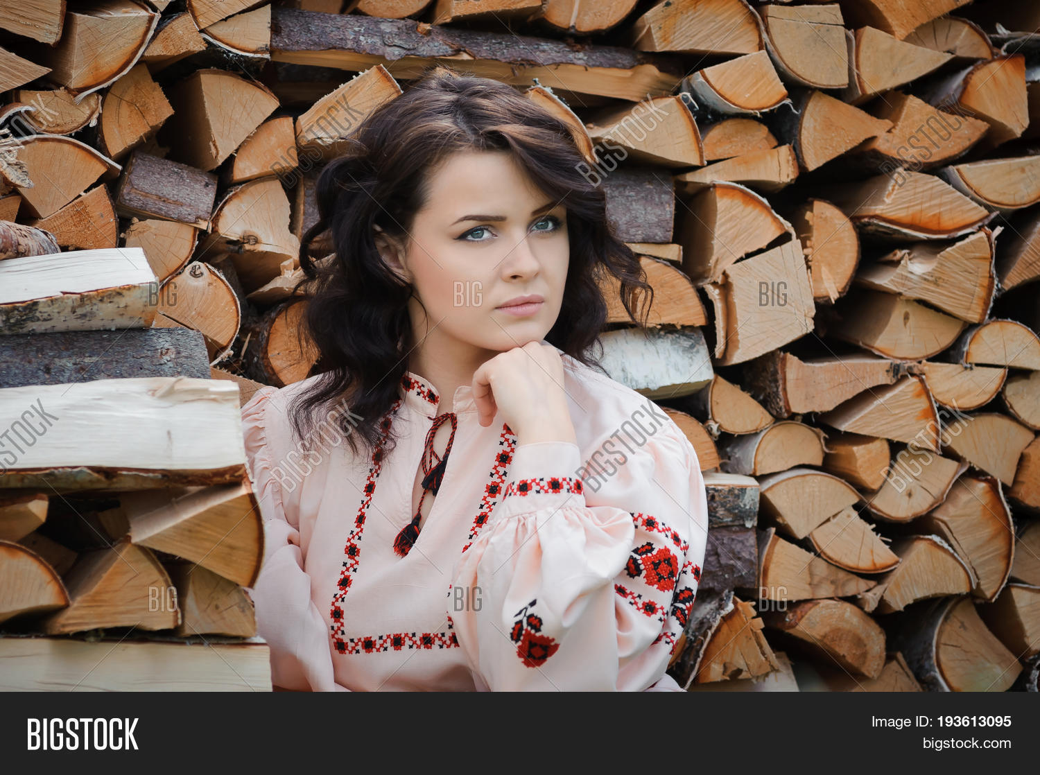 portrait of a beautiful girl in slavic clothes on the background