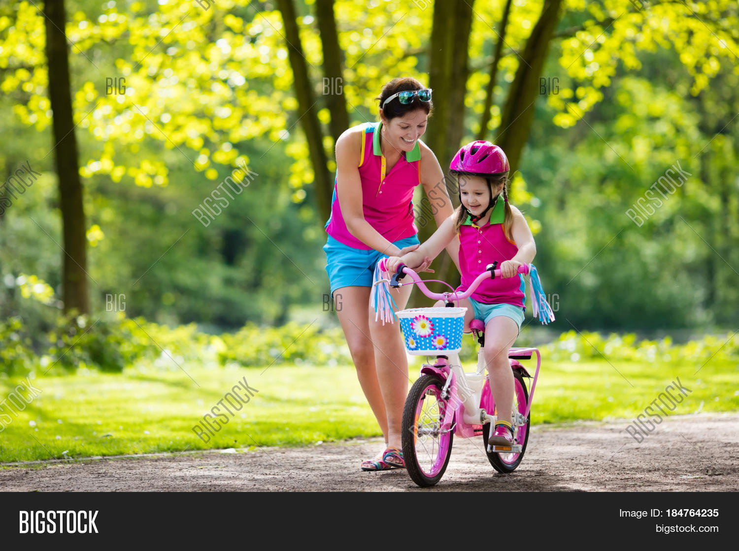 kid on bicycle in sunny park.