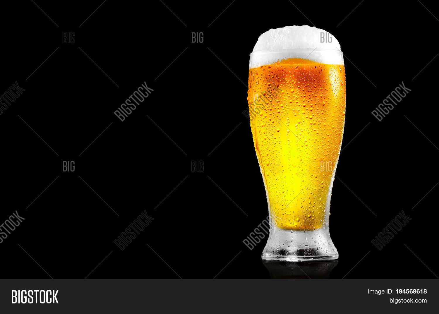 cold craft light beer in a glass with water drops.