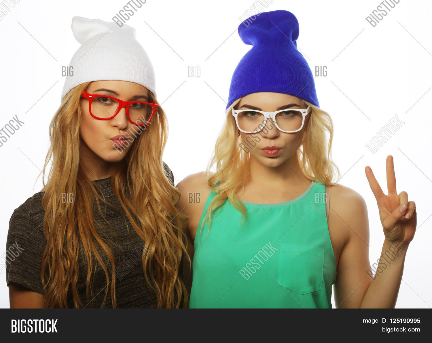 two young girl friends standing together and having fun.