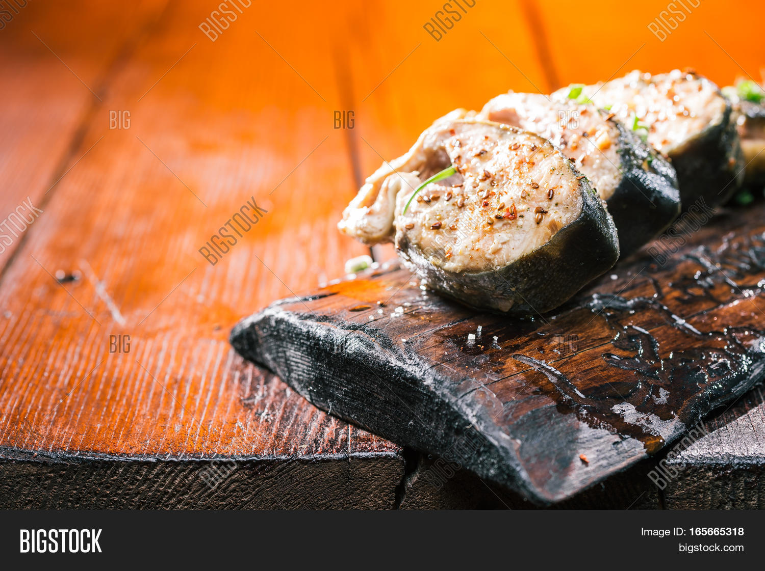 baked salmon with terragon and thyme on wood board.