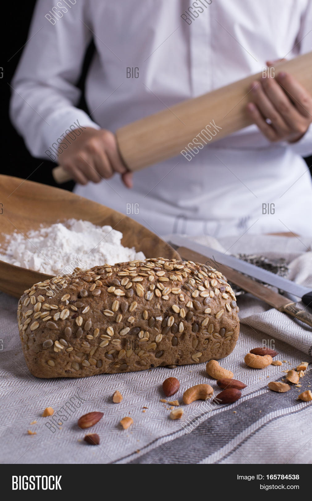 whole grain bread put on kitchen napkin decorated with almond