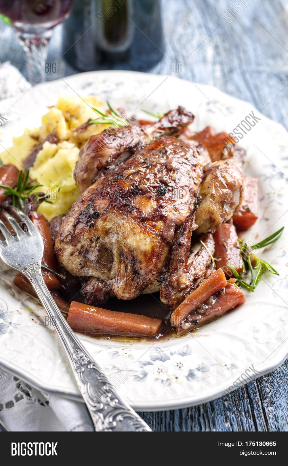 coq au vin with vegetable and potato puree in burgundy sauce as