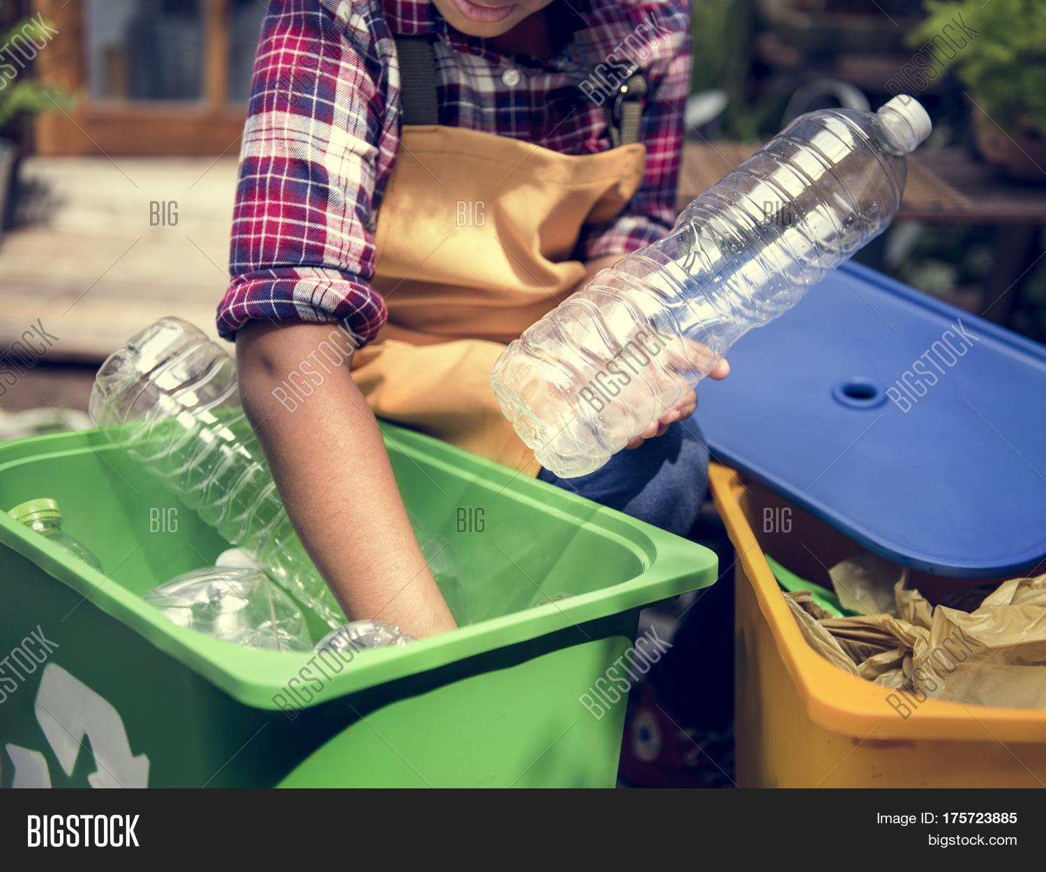 african descent kid separating recyclable trash