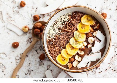 smoothie bowl topped with sliced banana, shredded coconut