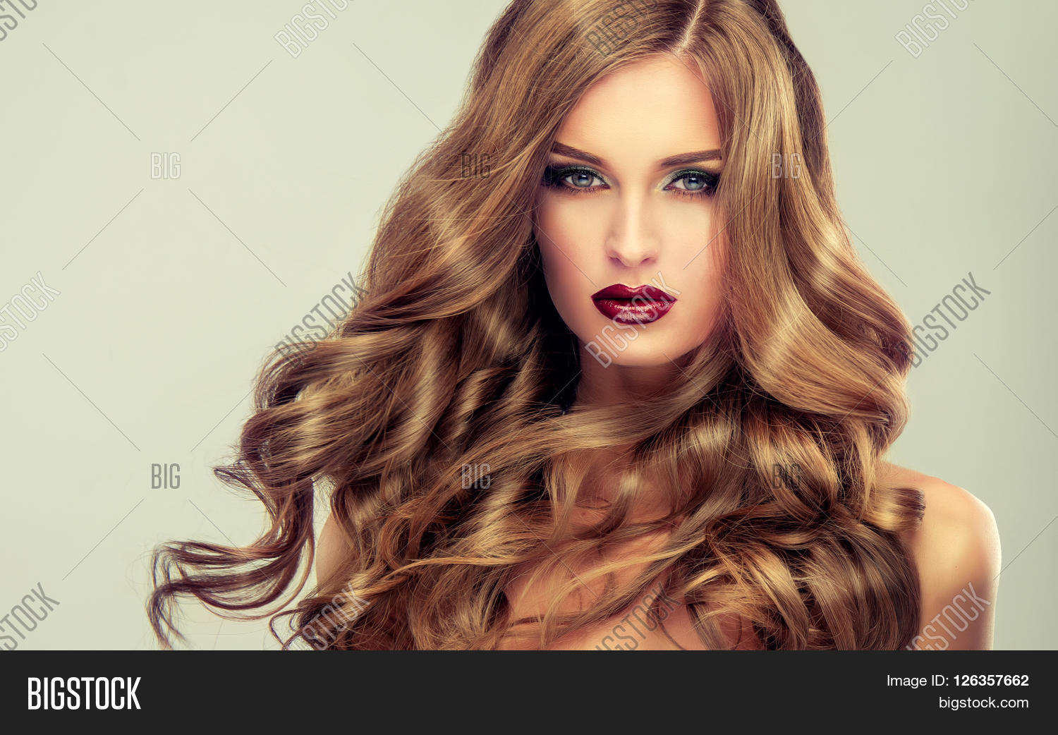 beautiful girl with long wavy hair .