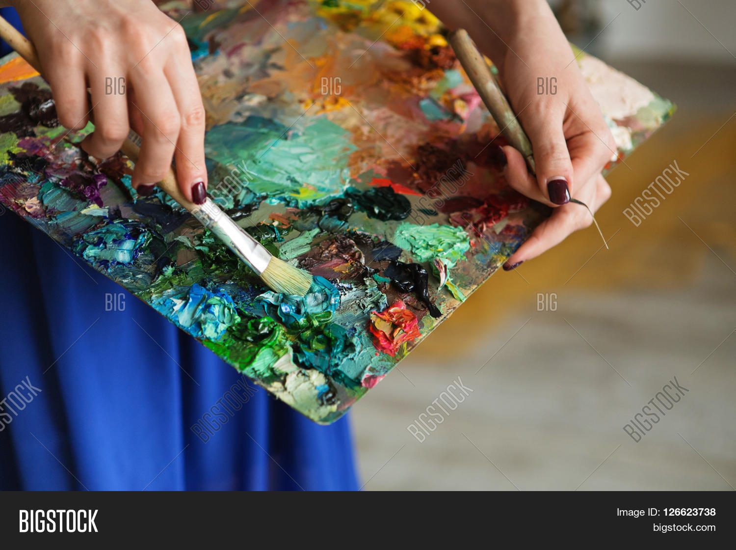 artist brush mix color oil painting on palette is holding in her