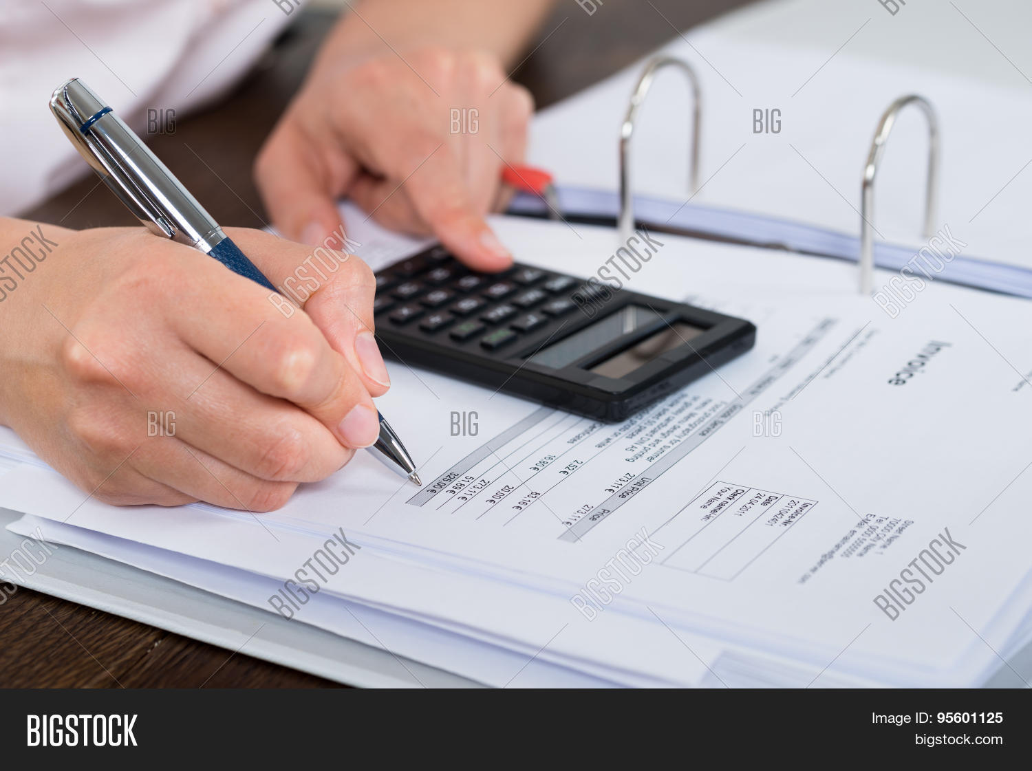 close-up of accountant doing calculation with calculator in