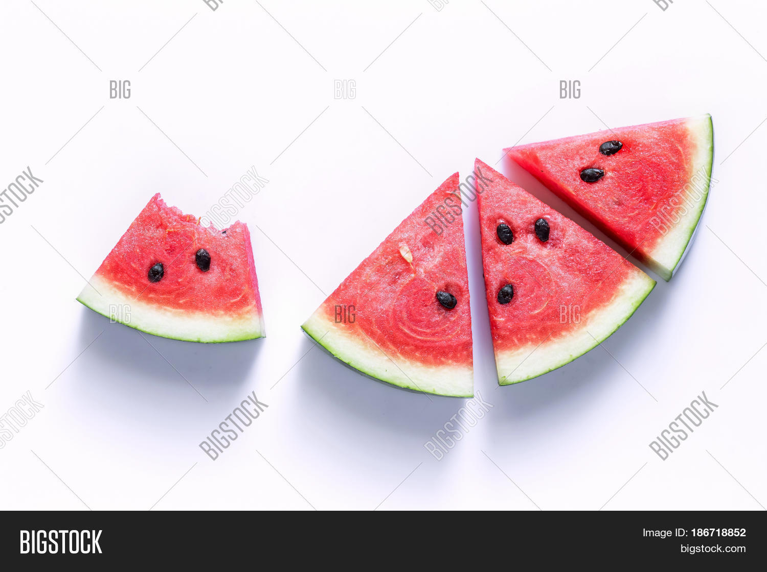 watermelon sliced into a slice of wood on an white background.