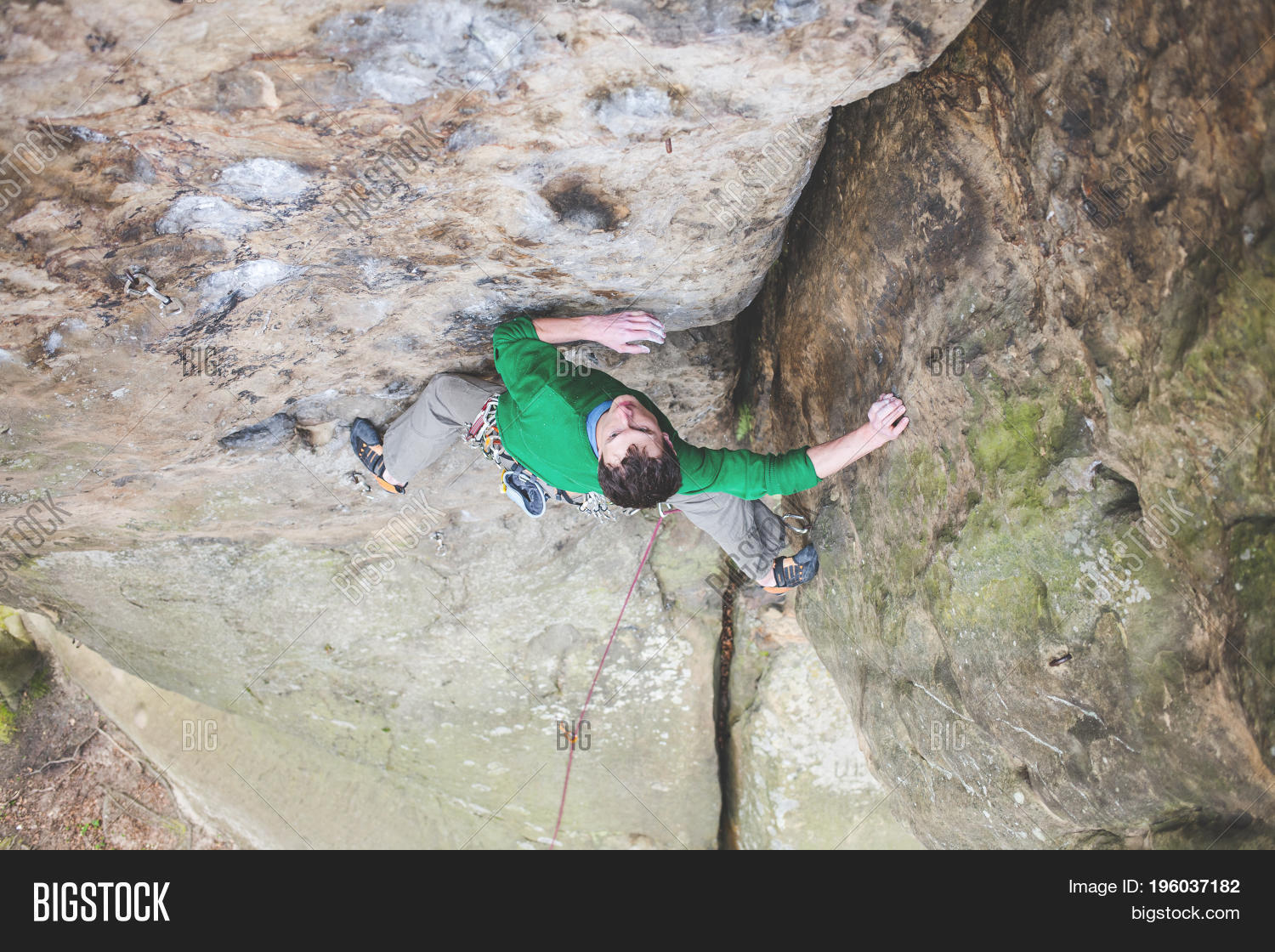 male rock climber climbs up the mountain.