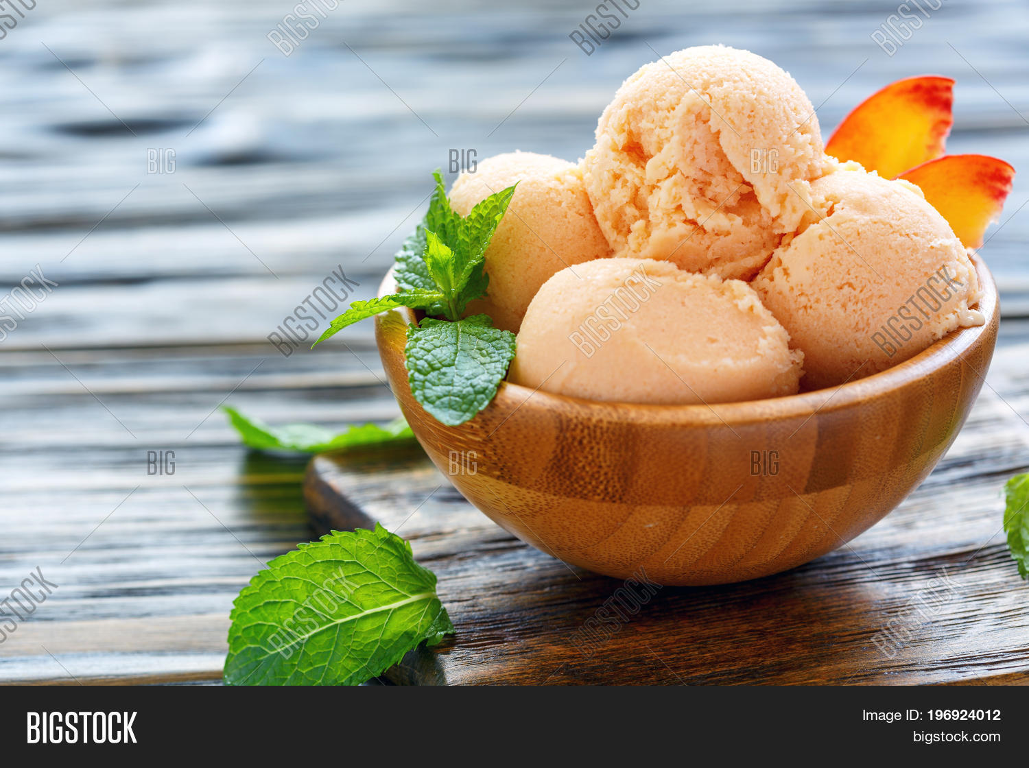 peach ice cream peach slices and mint leaves wooden bowl on old