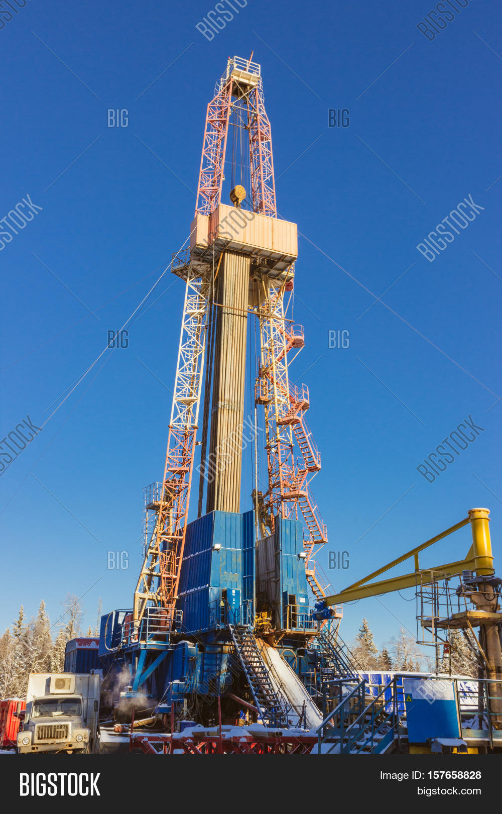 land onshore oil drilling rig blue sky