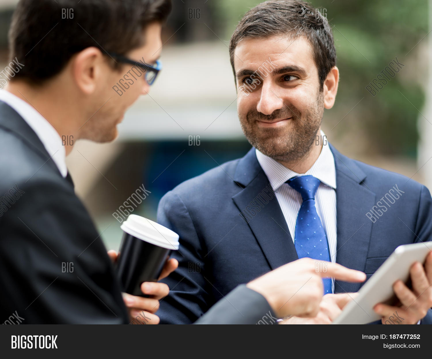 two businessmen talking outdoors