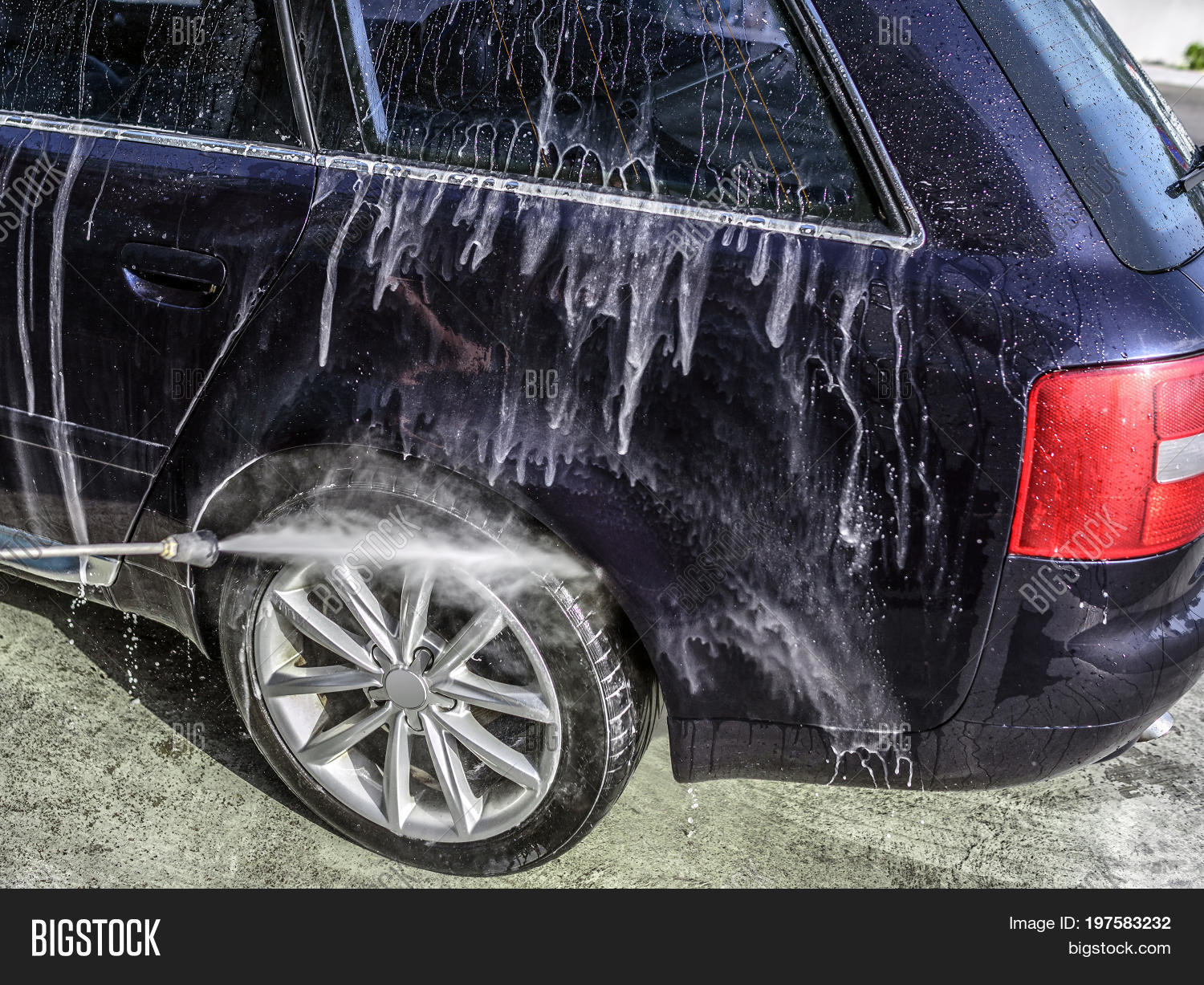 high-pressure washing car outdoors. car washing under the open s