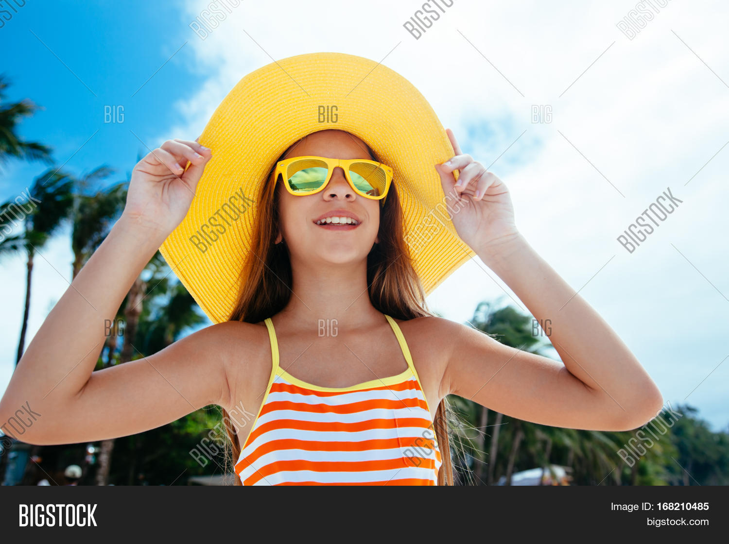 10 years old child girl relaxing on the beach on tropical island