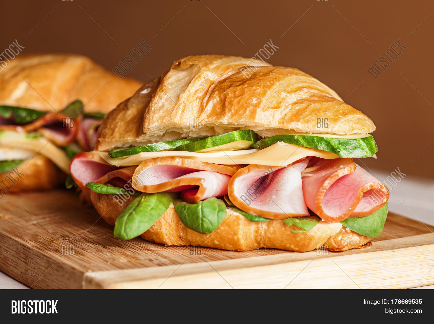 croissants sandwiches on the wooden cutting board.