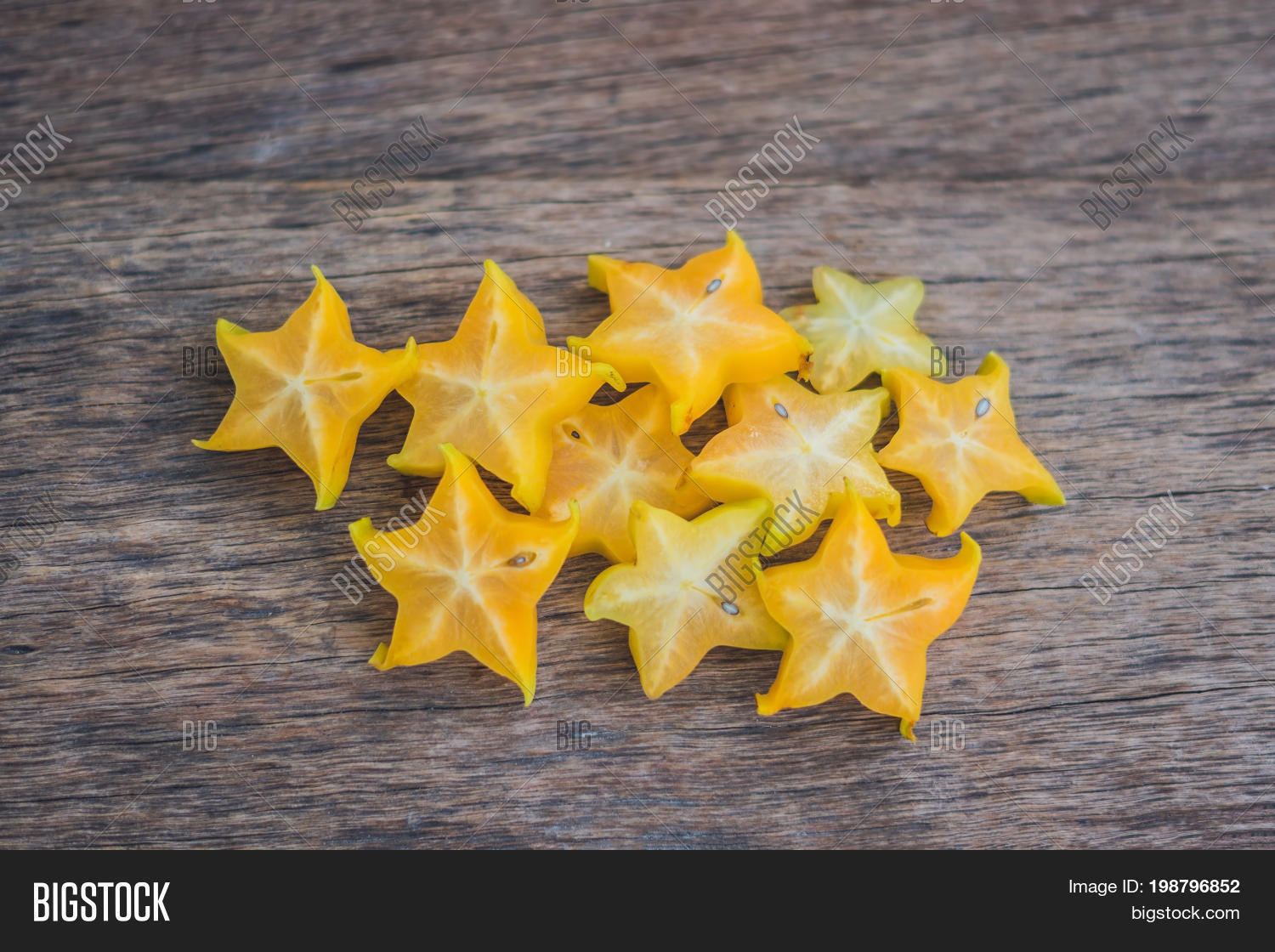 star fruits sliced on wood background. selective focus.