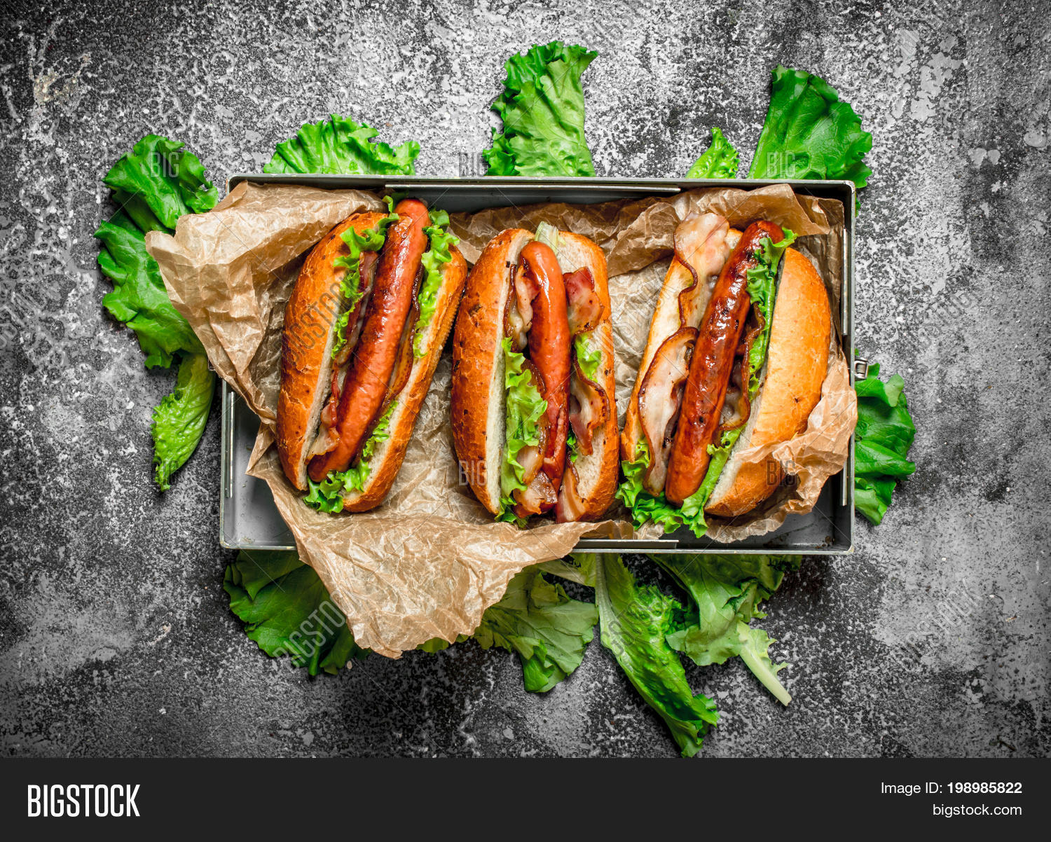 hot dogs beef barbecue with hot sauces. on rustic backgroud..