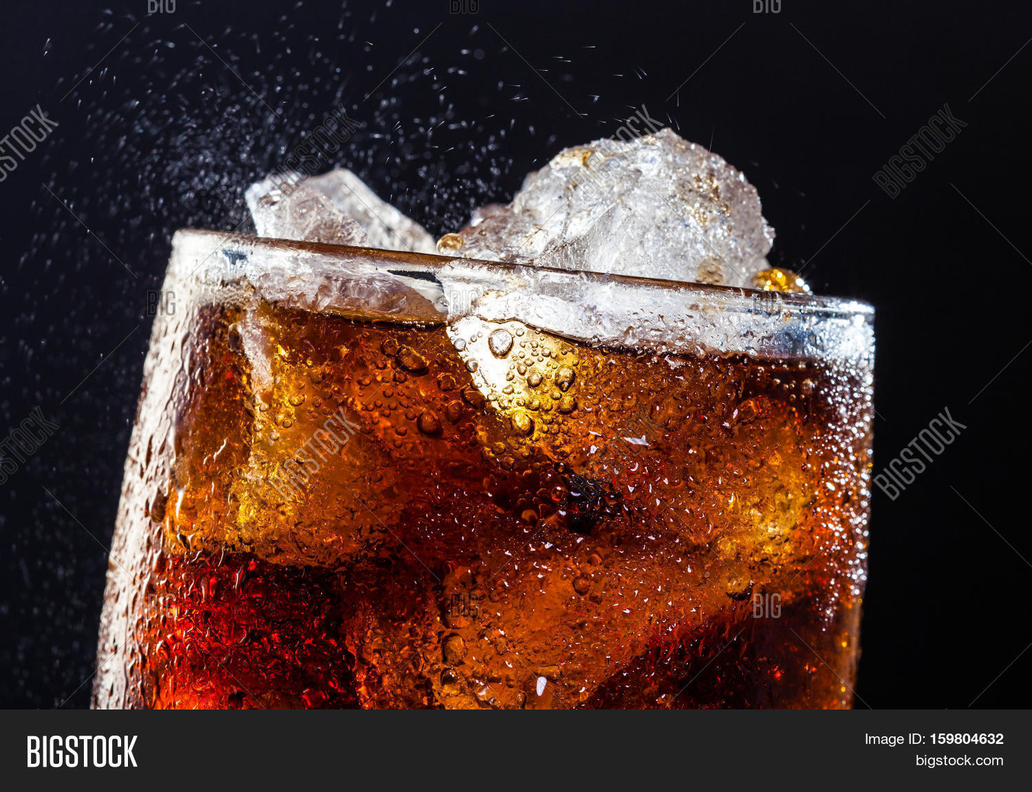 a cool glass of cola drink with ice bubbles and fizz