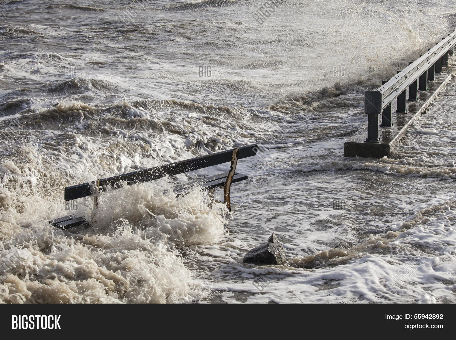 a wooden bench after heavy rains and storm in a coastal town in
