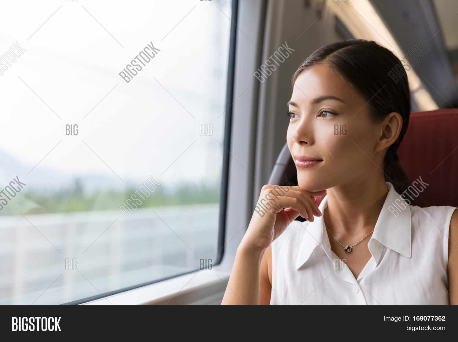 asian woman traveler contemplating outdoor view from window of