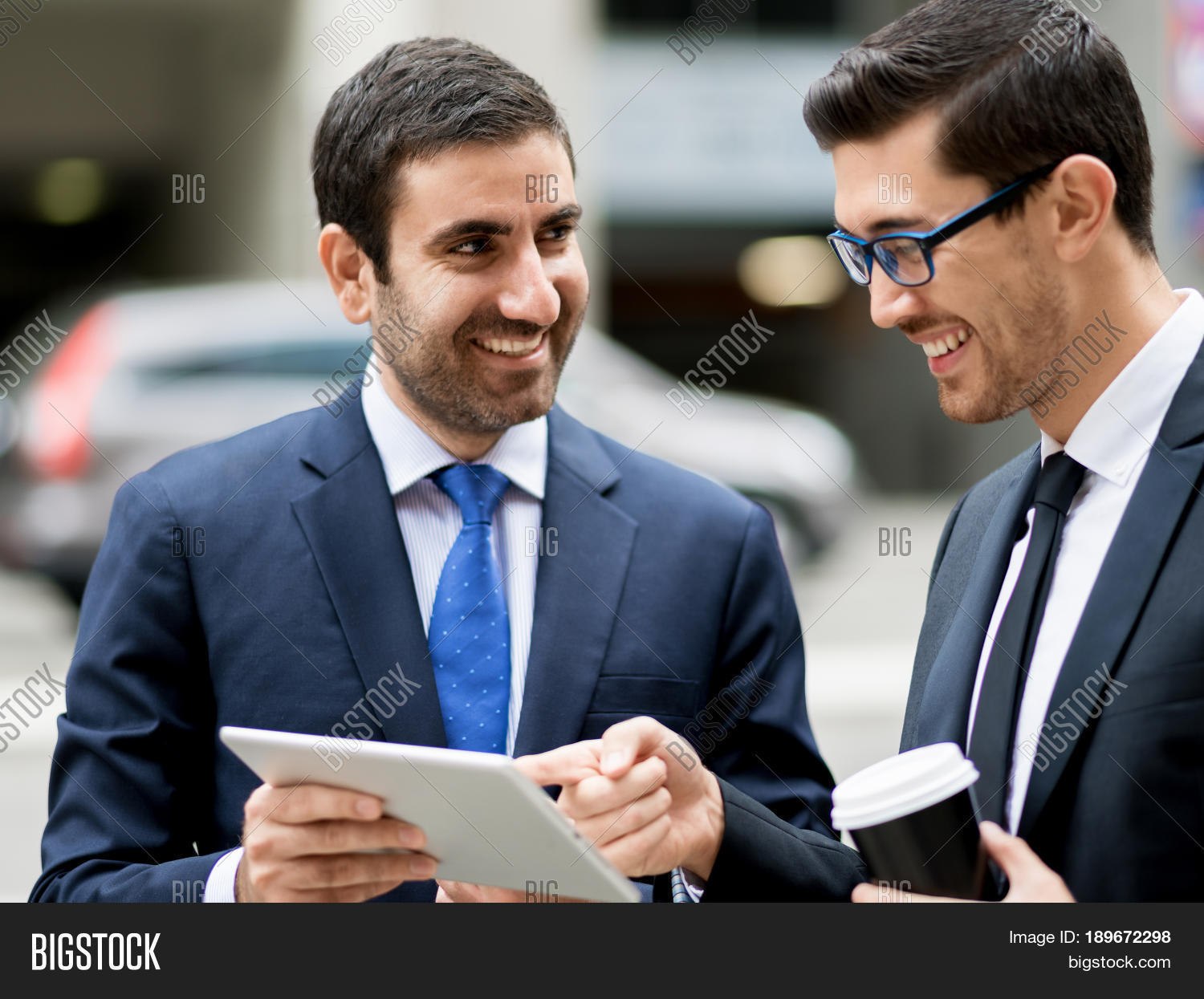 two businessmen talking outdoors