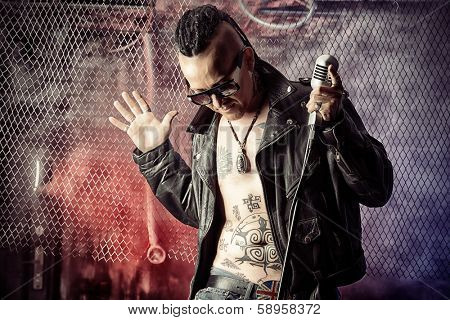 rock singer with a microphone over grunge background.